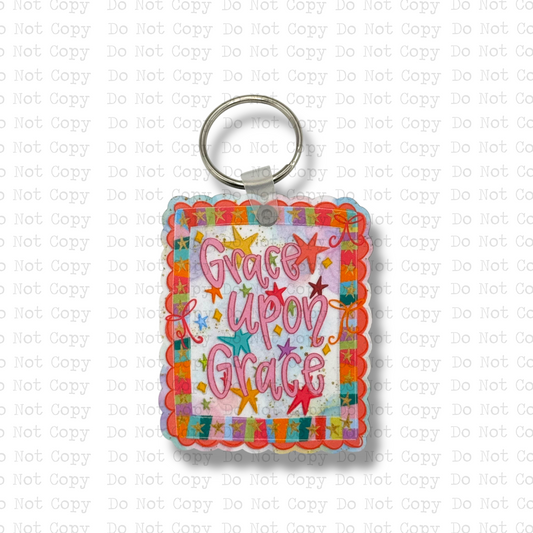 Custom-shaped contoured scalloped square MDF wood sublimation keychain blank kit featuring a colorful retro star Christian design with the text Grace upon Grace in pink script, shown with keyring hardware.